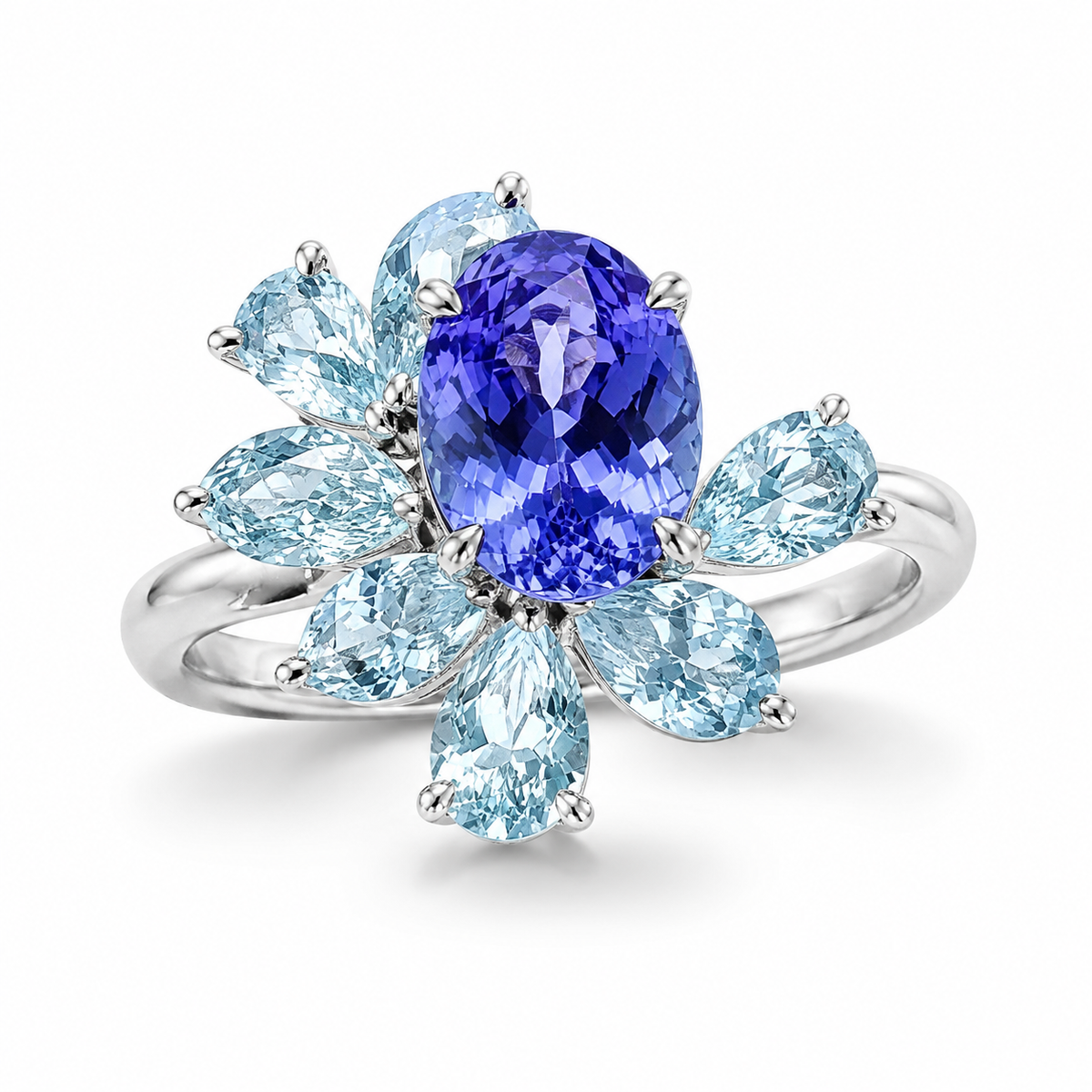 Celeste bespoke gemstone cluster ring with vivid blue oval centre stone and pear-cut light blue gemstones, handcrafted by Syna Jewellery